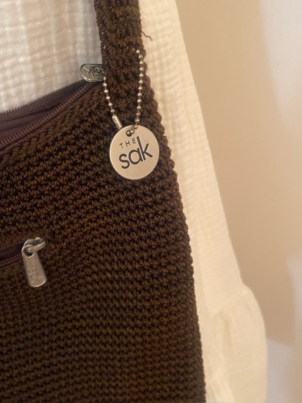 The Sak Chocolate Brown Crochet Shoulder Bag with Branded Charm